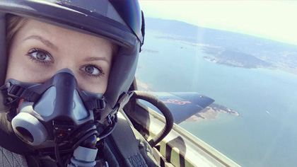 Woman in jet wearing helmet and mask