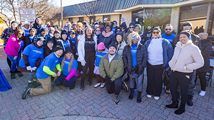 group of people outside doing community service in neighborhood