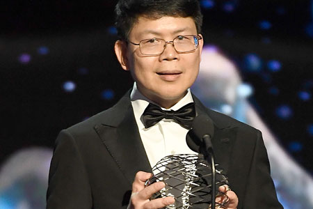Chen holding award for breakthrough