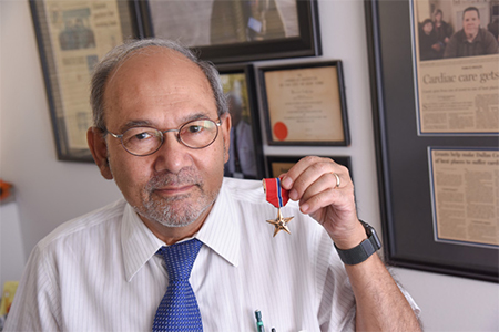  Dr. Ahamed Idris holding up bronze star