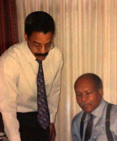 Dr. Louis Sullivan and Dr. Paul Sullivan at desk