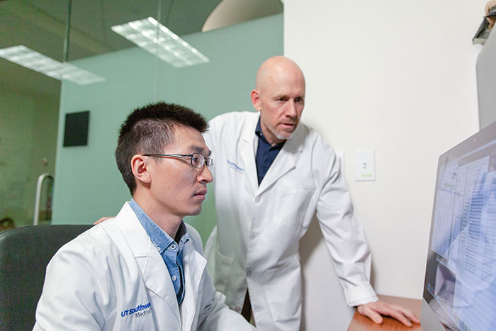 Dr. Zixu Liu (left) and Dr. Neal Alto working together in the lab