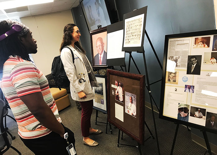 Students view display honoring Dr. Lee Henry