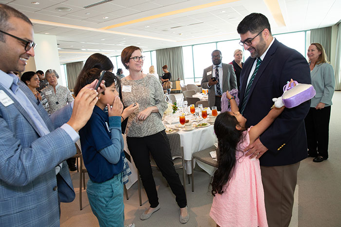 Dr. Tambar’s daughter reaches out to give her father a hug upon his receipt of the 2019 Norman Hackerman Award in Chemical Research as family and colleagues offer congratulations.