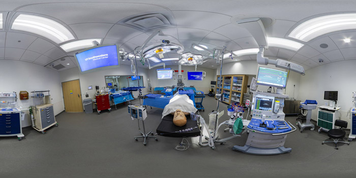 Wide angle shot of room with dummy and medical equipment