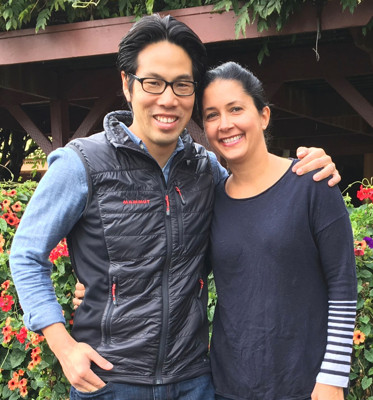 Man and woman in garden holding each other smiling