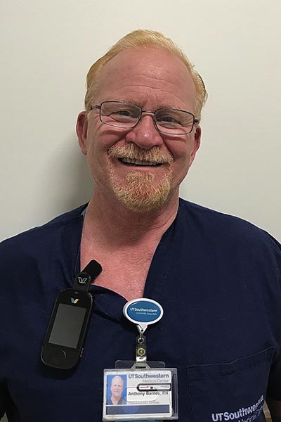 Man with red hair, goatee, wearing scrubs