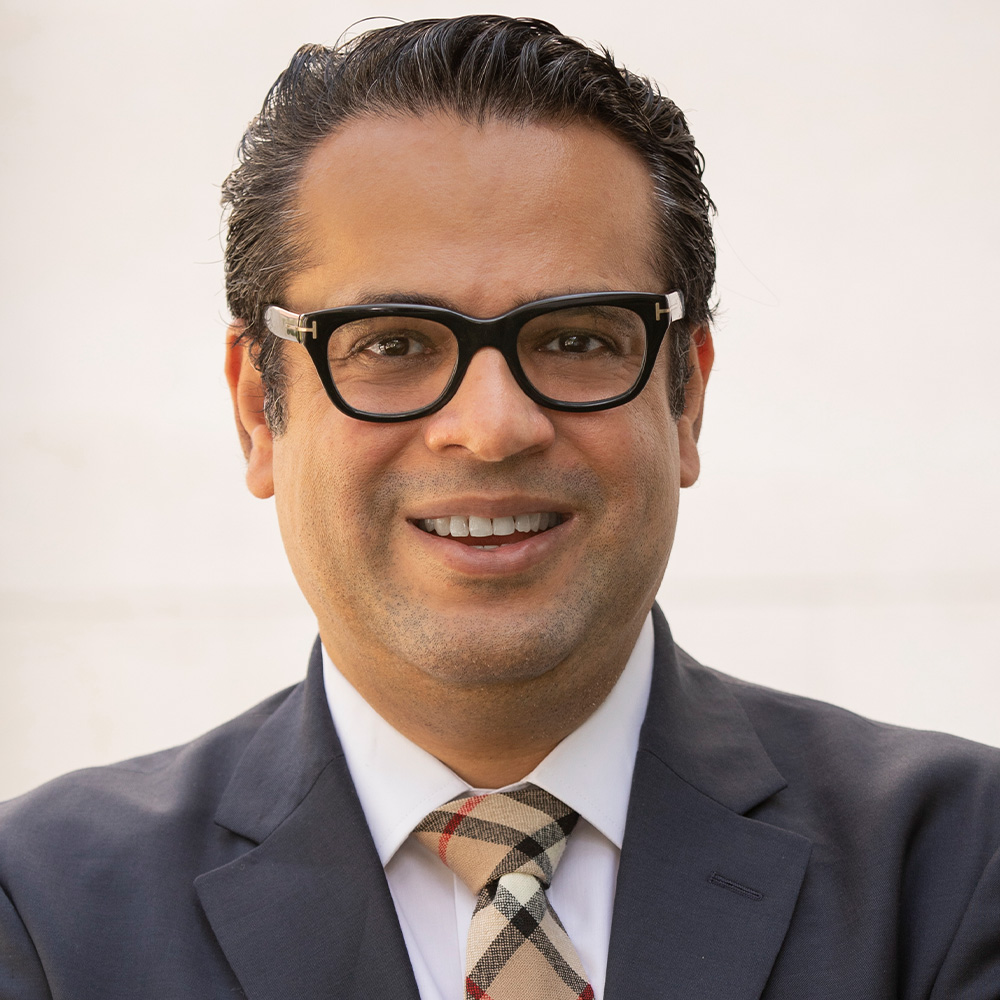 Dr. Saad Omer, smiling man with dark hair and glasses.