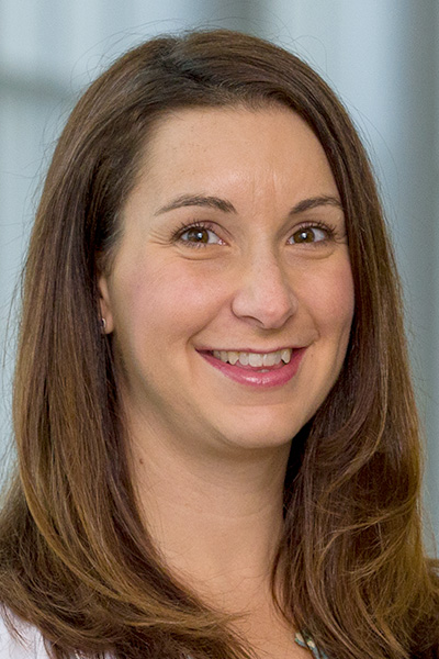 Joscelyne Dracca headshot - smiling woman with long light brown hair