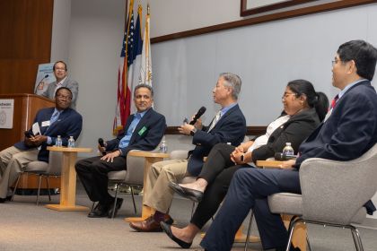 faculty on stage and at podium during 2024 biomed engineering symposium