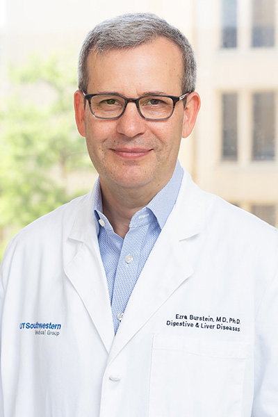 Dr. Ezra Burstein headshot: white man in lab coat and blue shirt with gray hair and glasses