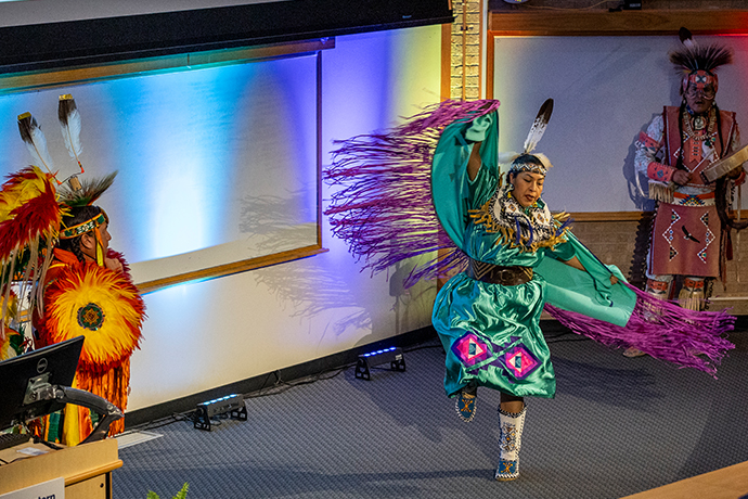 native american dancer in costume performs on stage