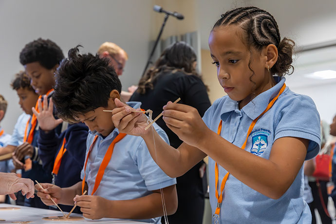 group of Biomedical Prep students in blue school uniforms do lab experiments