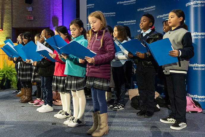 group of children from Biomedical Prep Academy sing on stage during MLK event 2025