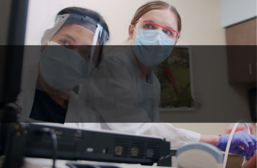 two medical students with face masks on