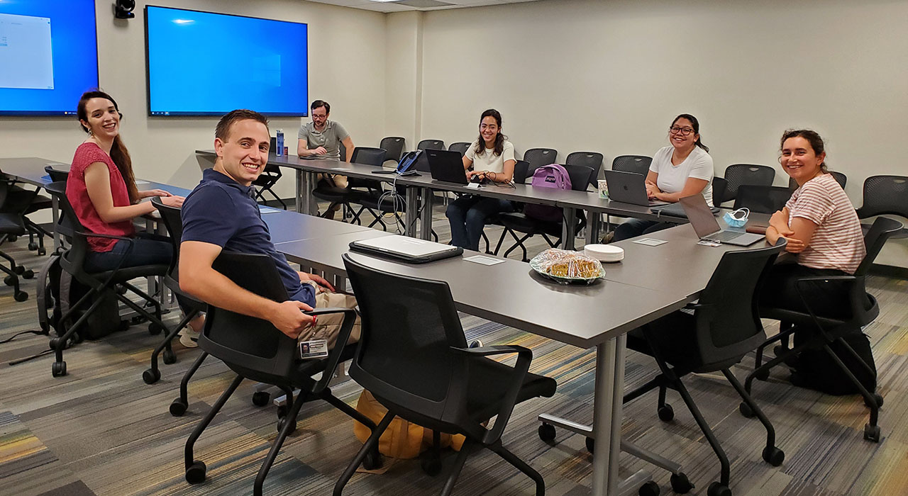 A group of smiling students seated in a conference room