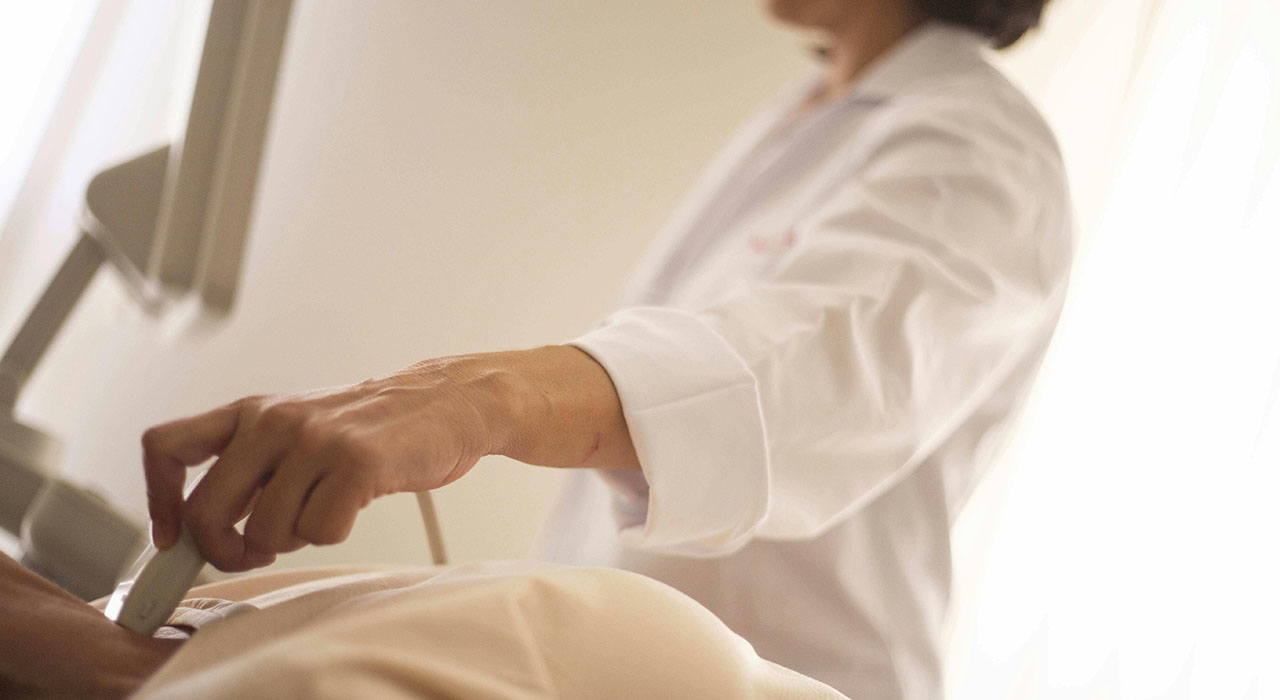 Physician performs ultrasound on a patient