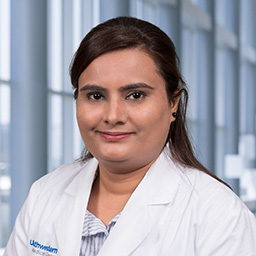 Dr. FNU Anum wearing a white lab coat