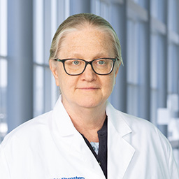 Dr. Joyce Repa wearing a white lab coat