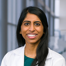 Dr. Cristina Thomas wearing a white lab coat