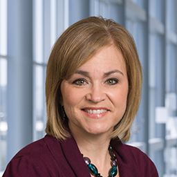 Traci Child wearing a maroon shirt, standing in the Clements University Hospital