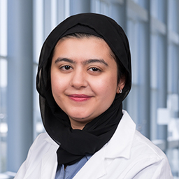 Dr. Fatima Mahmood wearing a white lab coat standing in the Clements University Hospital lobby