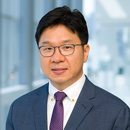 Dr. Makato Ishii wearing a blue suit and purple tie