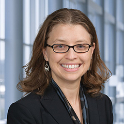 Dr. Francesca Lee wearing glassed and a dark jacket