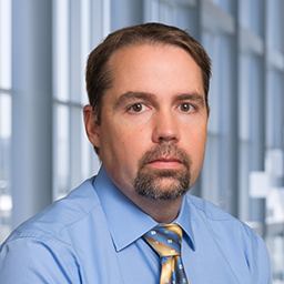 James Sanders wearing a blue shirt and striped tie