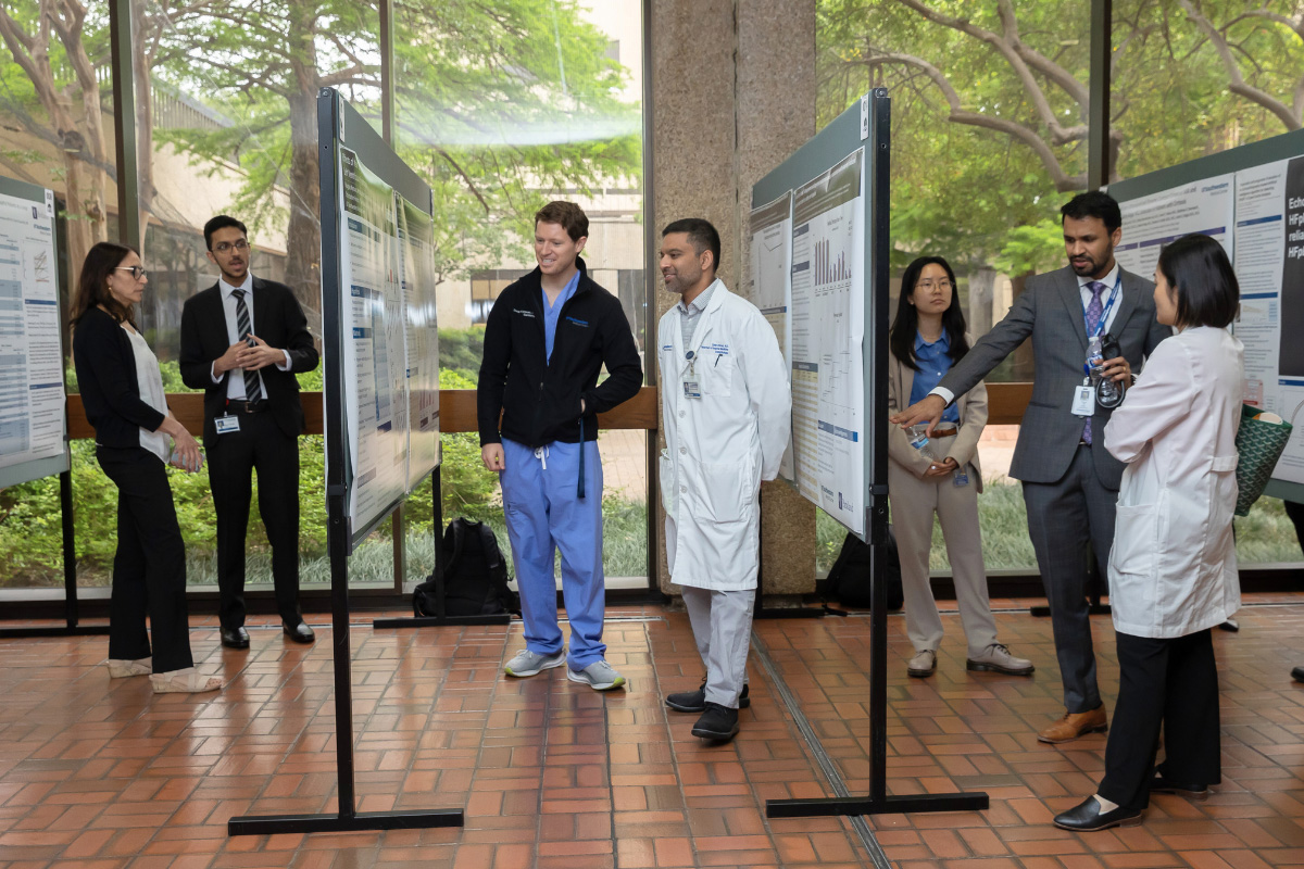 various symposium participants reviewing posters