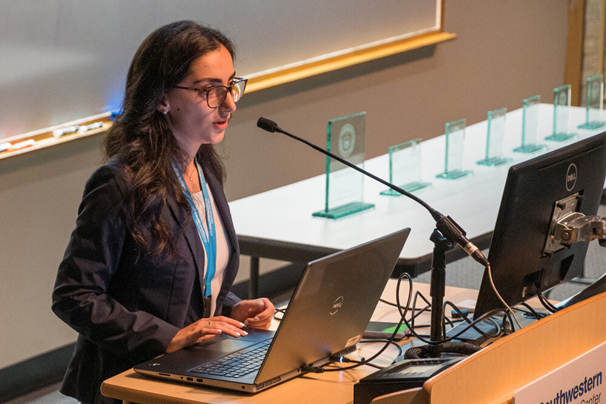 Dr. Angela Duvalyan, at a podium presenting at Seldin Sympoium