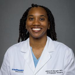 Female Orthopaedic Surgery Resident wearing a white coat