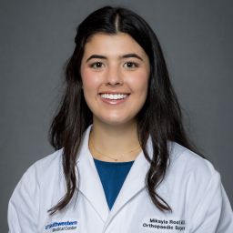 Female Orthopaedic Surgery Resident wearing a white coat