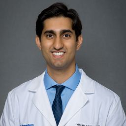 Male Orthopaedic Surgery Residents wearing a white coat