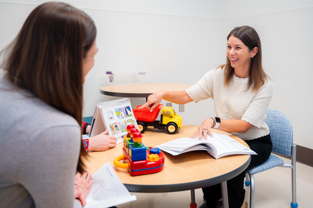 Dr. Bar sitting at a table discussing clinical practices