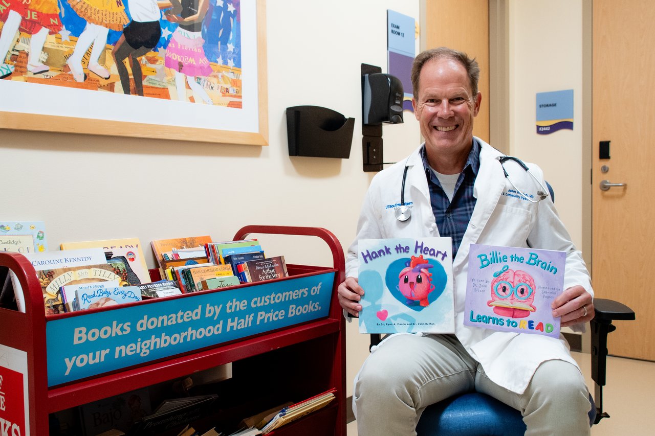 Dr. Hutton posed with his books
