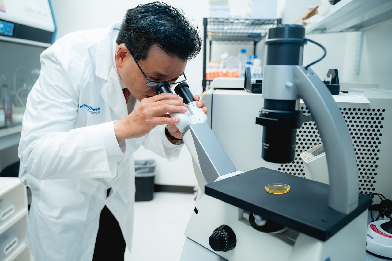 Dr. Koh looking at the microscope