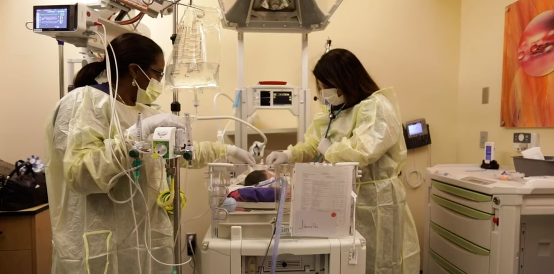 two doctors caring for infant