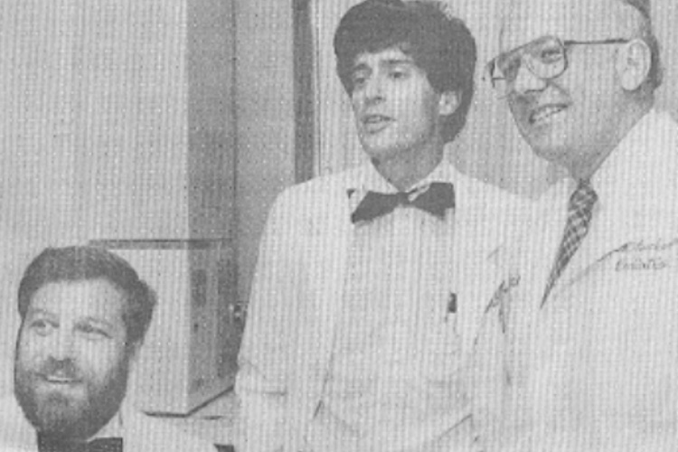 Three men in lab coats in the 1980's
