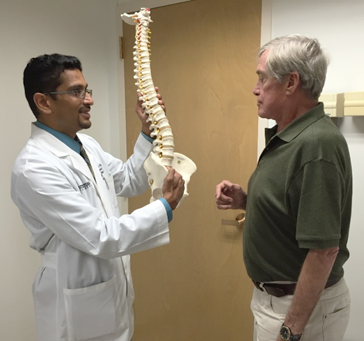 Dr. Patel with a spine patient