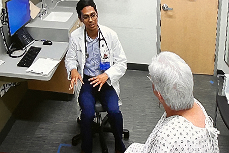 Doctor speaking with patient in exam room