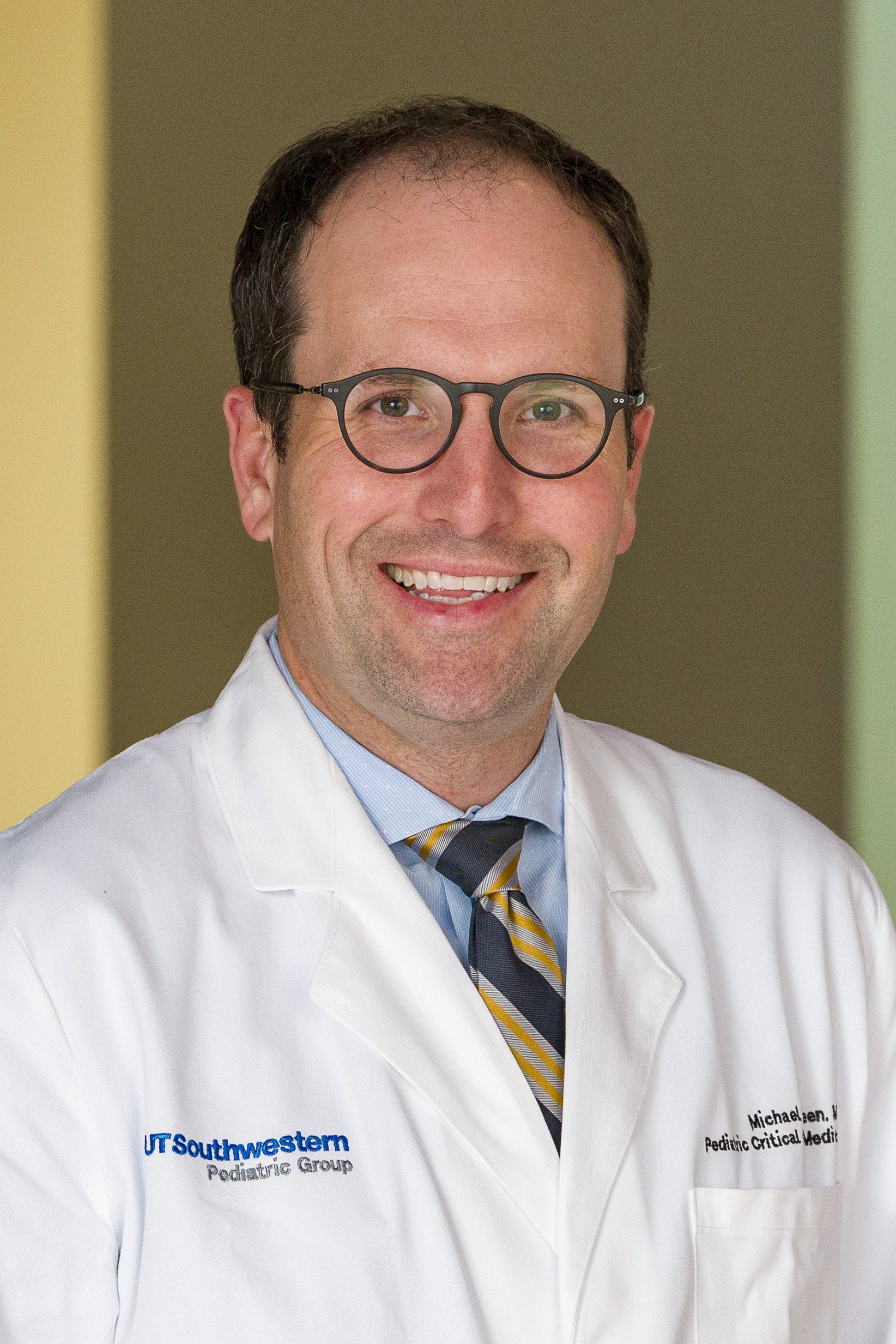 Dr. Green, a smiling man with thinning hair wearing glasses and a white lab coat.