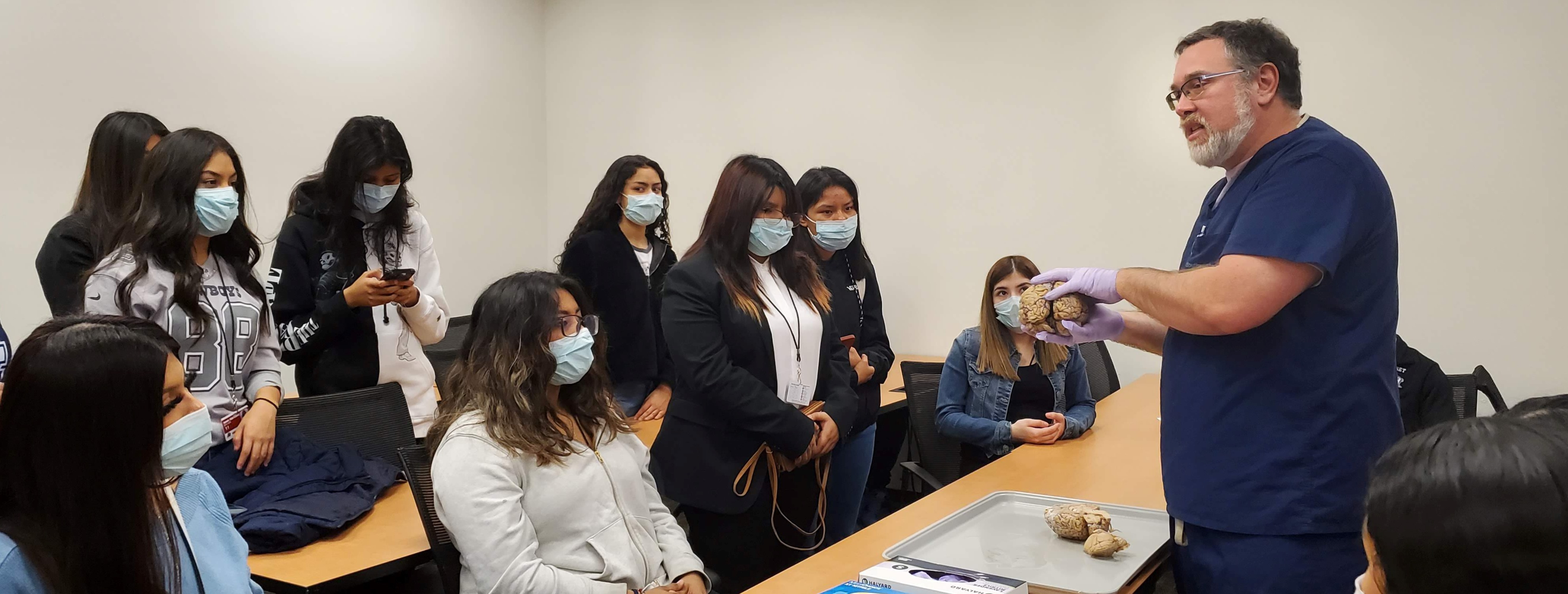 High school students learn about brain histology from neuropathologist Dr. Bret Evers