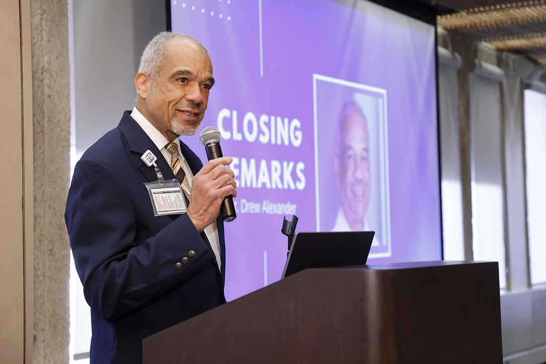 Dr. Alexander speaks while standing at a podium