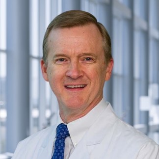 smiling male in a white shirt and dark tie