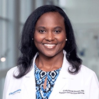 smiling woman in a lab coat and colorful top