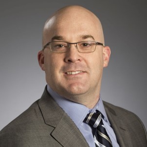 smiling man wearing a suit