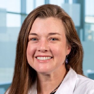 smiling woman in a white lab coat