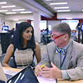 woman and man engaged in a discussion in an academic setting