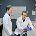 Two faculty members in white coats